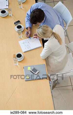 Picture - Colleagues playing noughts and crosses. Fotosearch