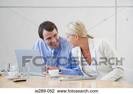 Stock Image - Colleagues smiling. Fotosearch