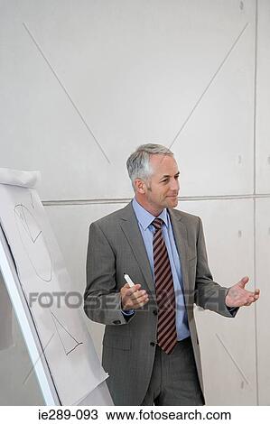 Stock Image - Man giving presentation. Fotosearch