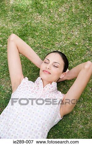 Woman sleeping on grass View Large Photo Image Stock Photo - Woman sleeping on grass. Fotosearch