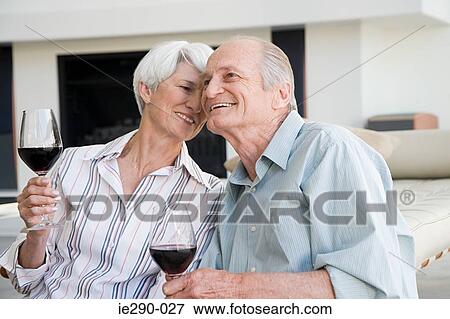 A senior couple having a glass of red wine View Large Photo Image Stock Photo - A senior couple having a glass of red wine. Fotosearch