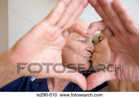 Stock Image - A senior couple kissing. Fotosearch
