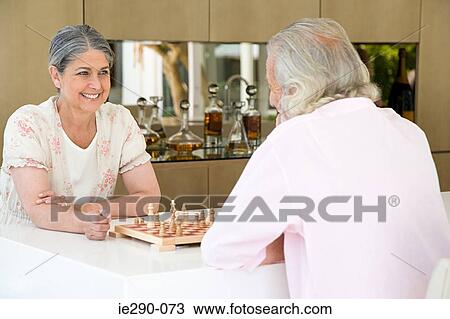 A senior couple playing chess View Large Photo Image Stock Image - A senior couple playing chess. Fotosearch