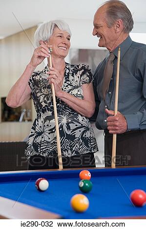 A senior couple playing pool View Large Photo Image Stock Image - A senior couple playing pool. Fotosearch