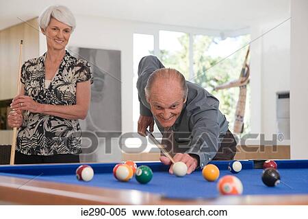 A senior couple playing pool View Large Photo Image Stock Photography - A senior couple playing pool. Fotosearch