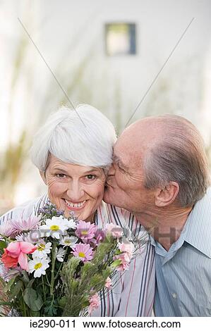 A senior man kissing a senior woman on the cheek View Large Photo Image Stock Image - A senior man kissing a senior woman on the cheek. Fotosearch