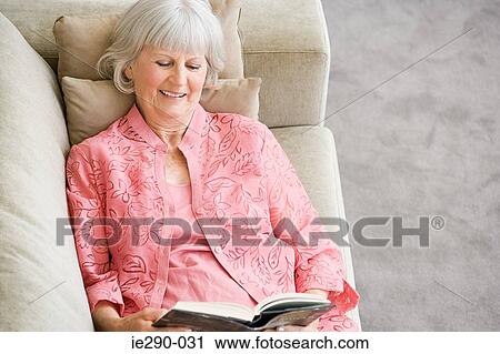 A senior woman reading a book View Large Photo Image Stock Image - A senior woman reading a book. Fotosearch