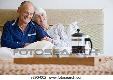 Senior couple having breakfast in bed View Large Photo Image Stock Image - Senior couple having breakfast in bed. Fotosearch