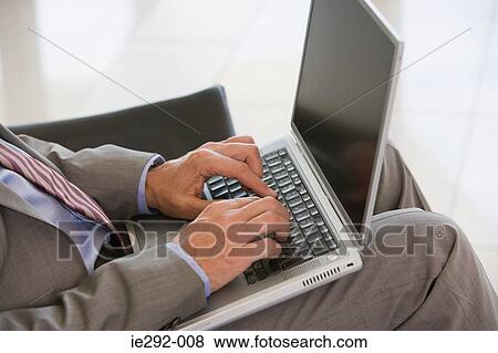 Stock Photo - Businessman typing on laptop. Fotosearch