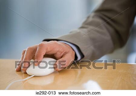Businessman using a mouse View Large Photo Image Stock Image - Businessman using a mouse. Fotosearch