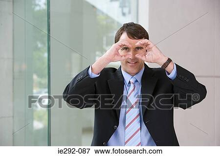 Businessman with fake binoculars View Large Photo Image Stock Photo - Businessman with fake binoculars. Fotosearch