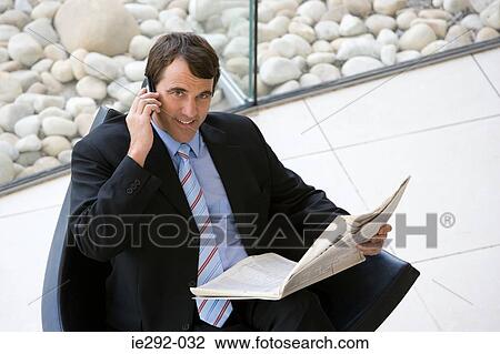 Businessman with newspaper and telephone View Large Photo Image Stock Image - Businessman with newspaper and telephone. Fotosearch