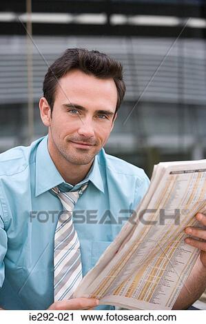 Office worker reading a newspaper View Large Photo Image Stock Image - Office worker reading a newspaper. Fotosearch