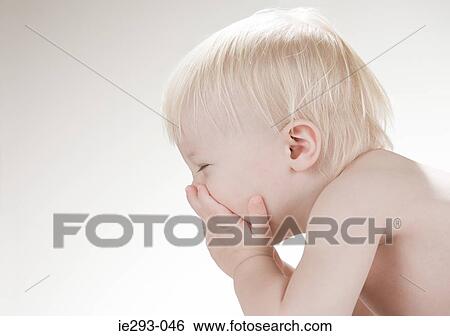 A baby boy covering his face View Large Photo Image Stock Photograph - A baby boy covering his face. Fotosearch