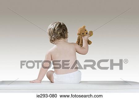 Rear view of a baby girl and a teddy bear View Large Photo Image Stock Image - Rear view of a baby girl and a teddy bear. Fotosearch