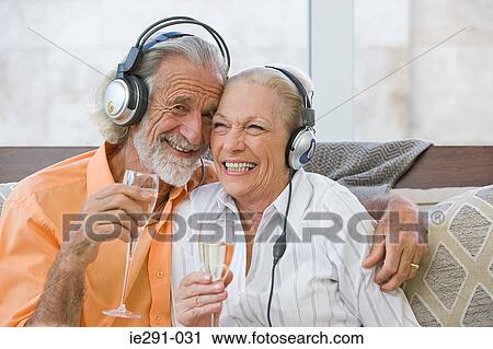 Couple with champagne and headphones View Large Photo Image Stock Image - Couple with champagne and headphones. Fotosearch