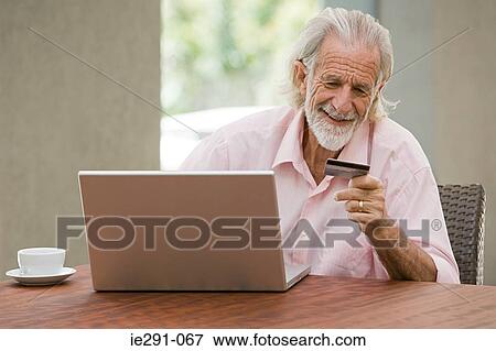 Stock Photo - Man shopping on internet. Fotosearch