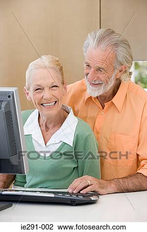 Stock Image - Senior couple using computer. Fotosearch