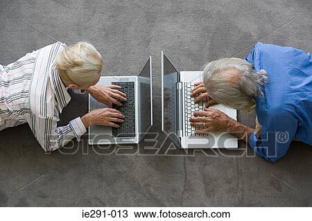 Senior couple using laptops View Large Photo Image Stock Image - Senior couple using laptops. Fotosearch