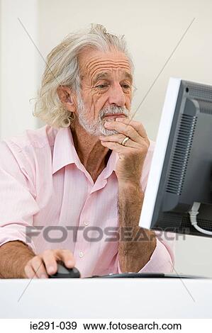 Senior man using computer View Large Photo Image Stock Photo - Senior man using computer. Fotosearch