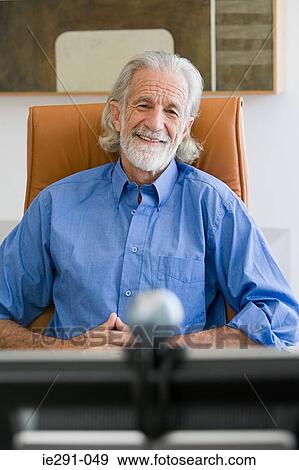 Senior man using webcam View Large Photo Image Stock Photo - Senior man using webcam. Fotosearch