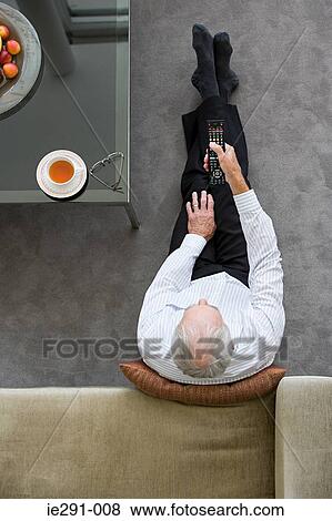 Senior man watching television View Large Photo Image Stock Photo - Senior man watching television. Fotosearch