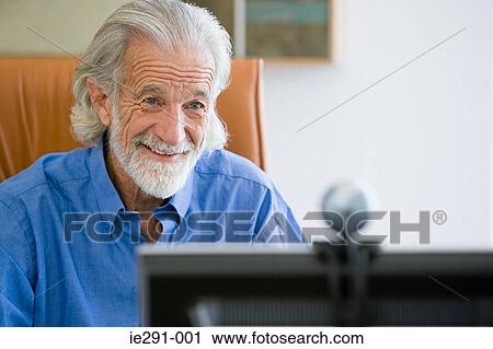 Stock Image - Senior man with webcam. Fotosearch