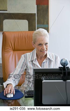 Senior woman using computer View Large Photo Image Stock Photography - Senior woman using computer. Fotosearch