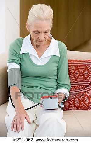 Woman using blood pressure gauge View Large Photo Image Stock Image - Woman using blood pressure gauge. Fotosearch