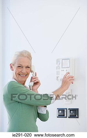Woman using intercom View Large Photo Image Stock Image - Woman using intercom. Fotosearch