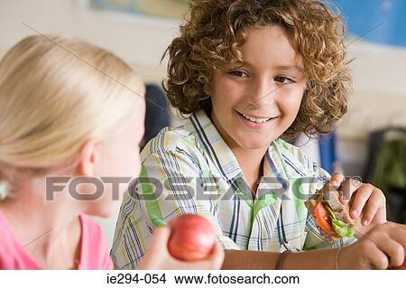 Boy and girl having packed lunch View Large Photo Image Picture - Boy and girl having packed lunch. Fotosearch