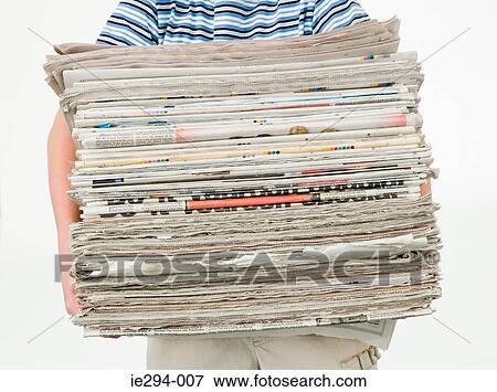 Boy carrying a stack of newspapers View Large Photo Image Stock Photo - Boy carrying a stack of newspapers. Fotosearch