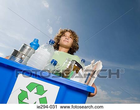 Boy carrying box of recycling View Large Photo Image Stock Image - Boy carrying box of recycling. Fotosearch