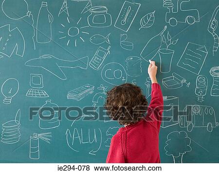 Stock Photo - Boy drawing on a blackboard. Fotosearch