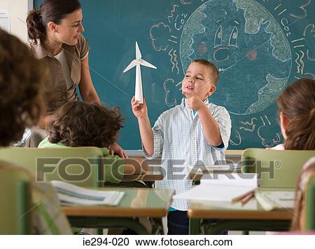 Boy holding wind turbine View Large Photo Image Stock Image - Boy holding wind turbine. Fotosearch