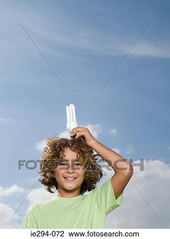 Boy with lightbulb above head View Large Photo Image Stock Image - Boy with lightbulb above head. Fotosearch