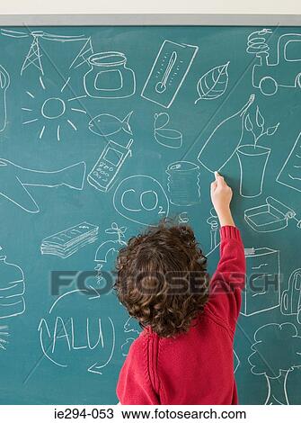 Boy writing on a blackboard View Large Photo Image Stock Image - Boy writing on a blackboard. Fotosearch