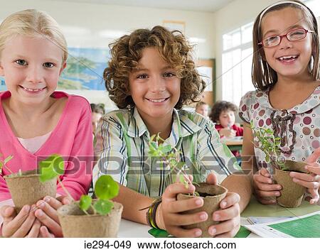 Children holding plants View Large Photo Image Stock Photo - Children holding plants. Fotosearch