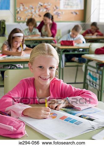 Girl in classroom View Large Photo Image Stock Photograph - Girl in classroom. Fotosearch
