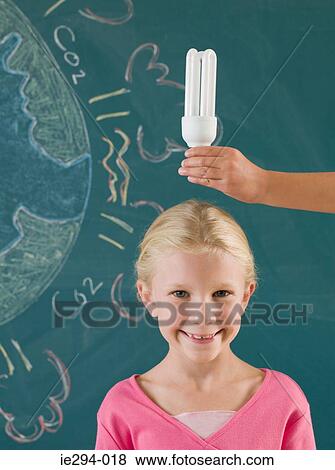 Girl with energy saving lightbulb View Large Photo Image Stock Photo - Girl with energy saving lightbulb. Fotosearch
