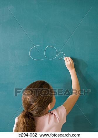 Girl writing on a blackboard View Large Photo Image Stock Image - Girl writing on a blackboard. Fotosearch