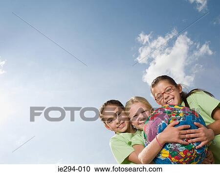 Girls holding an inflatable planet earth View Large Photo Image Stock Image - Girls holding an inflatable planet earth. Fotosearch