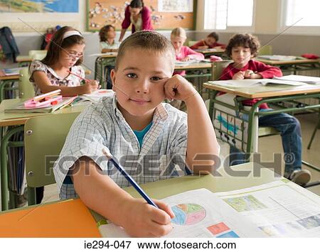 Portrait of a boy in class View Large Photo Image Stock Photo - Portrait of a boy in class. Fotosearch