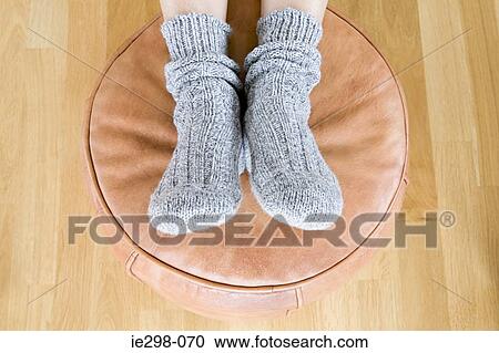 Person with feet on foot stool View Large Photo Image Stock Image - Person with feet on foot stool. Fotosearch