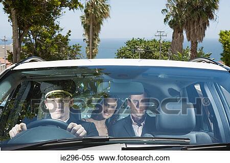 Couple being driven by chauffeur View Large Photo Image Stock Photography - Couple being driven by chauffeur. Fotosearch