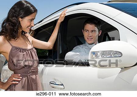 Flirty couple and car View Large Photo Image Stock Image - Flirty couple and car. Fotosearch