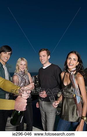 Friends having champagne View Large Photo Image Stock Photograph - Friends having champagne. Fotosearch