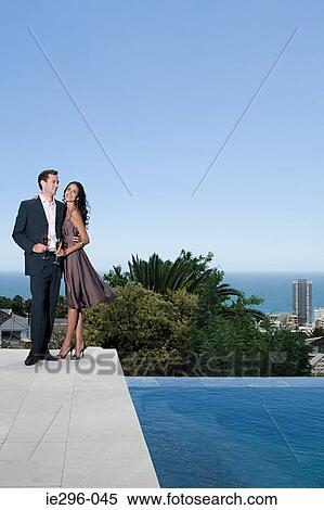 Glamorous couple by pool View Large Photo Image Stock Photography - Glamorous couple by pool. Fotosearch