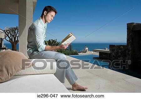 Man reading outdoors View Large Photo Image Stock Photo - Man reading outdoors. Fotosearch