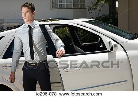 Young man by car View Large Photo Image Stock Photo - Young man by car. Fotosearch